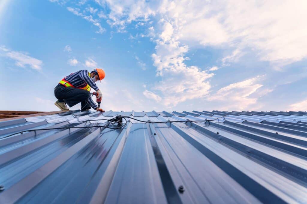 Metal Roof Installer Working On Roof